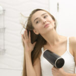 teen girl drying hair